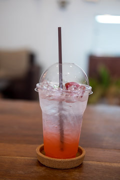 Closeup of strawberry soda in plastic glass