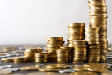 Increasing columns of gold coins on table