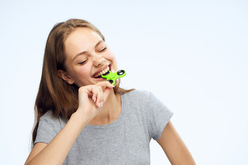 Beautiful young woman on white isolated background holds spinner