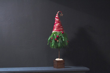 DIY Christmas tree on home mantelpiece at black wall background