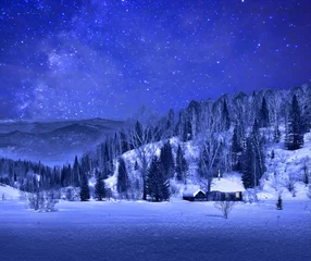 Wall murals Dark blue Small wooden house  in a night winter mountain landscape  with a beautiful starry sky