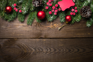 Christmas fir tree and decorations on wooden table.