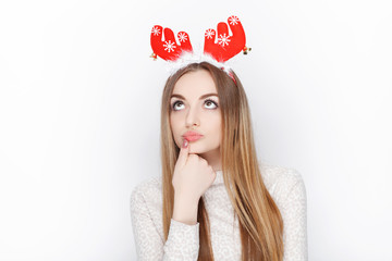 Beautiful emotional blonde female model wear santa deer headpiece. Christmas greetings concept.