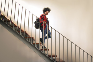 Trendy girl walking down a stair