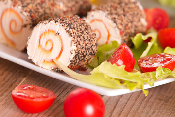 Goat cheese with salad and cherry tomatoes. 