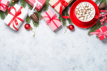Christmas background. Christmas present box, cup of chocolate with marshmallow and decorations on...