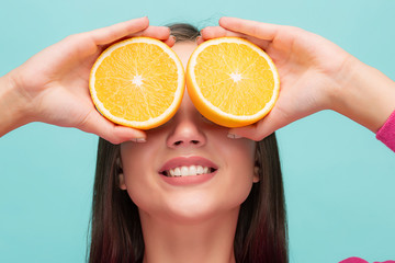 Beautiful woman's face with juicy orange