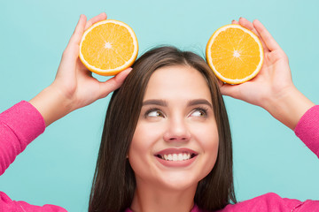 Beautiful woman's face with juicy orange