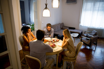 Young people celebrating New Year and drinking red wine