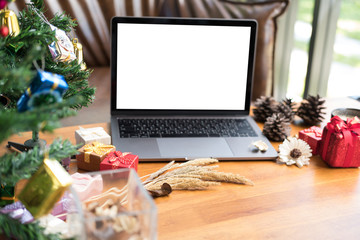 Naklejka na ściany i meble computer, xmas gift box, coffee cup on wood table. christmas and new year holiday celebration.