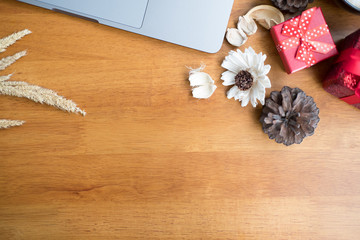 computer, xmas gift box on wood table. christmas and new year holiday celebration. Top view with copy space