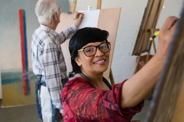 High angle portrait of woman drawing while standing by man