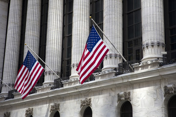 Flags wave outside the New York Stock Exchange, New York, USA