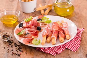 Grissini breadsticks with ham. 