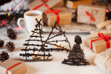 table with vintage toy xmas tree, gift boxes, cones of pine, christmas essentials, Christmas, new year, craft, decorating ideas, holidays details, festive mood