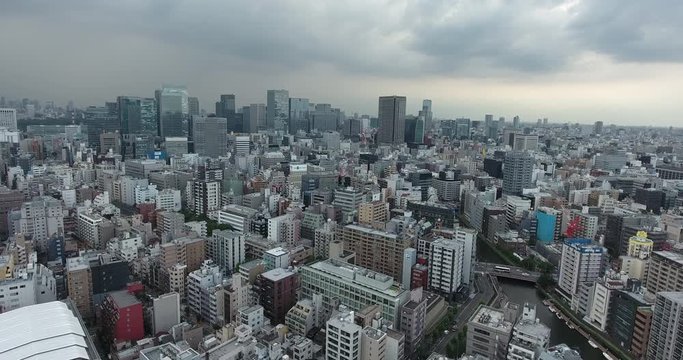 TOKYO, JAPAN – JUNE 2016 : Aerial shot over Tokyo Harbour area and central cityscape on a cloudy day