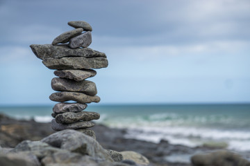 Close-up of stack of stones in perfect balance on a tranquil sunny beach in Fuerteventura, SpainClose-up of stack of stones in perfect balance on a tranquil sunny beach in Fuerteventura, Spain