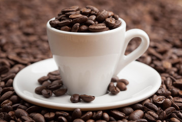 Ceramic cup full roasted coffee beans