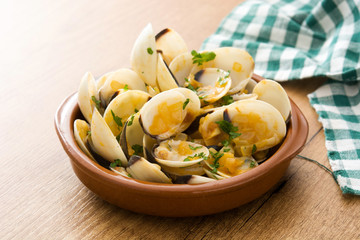 Clams with marinera sauce.Almejas a la marinera. Spanish recipe on wooden table