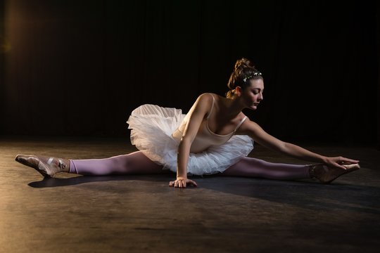 Female Ballet Dancer Stretching Before Dancing