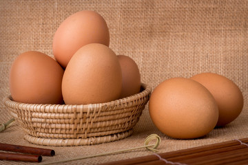 Eggs in a basket on  gunny (sackcloth)  background