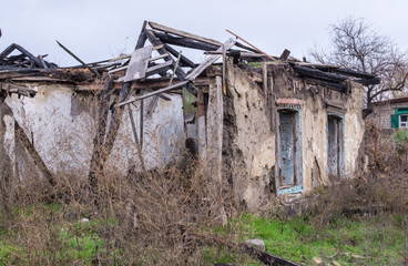 Fototapeta premium Poverty and unemployment. The walls of the old destroyed house