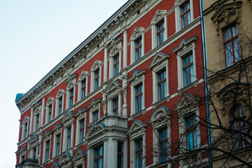 Fototapeta na wymiar red facaded brick building with white stucco details