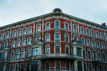 Fototapeta na wymiar red residential house with white stucco details