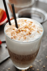 Tasty cocktail with coffee and caramel in glass on table, closeup