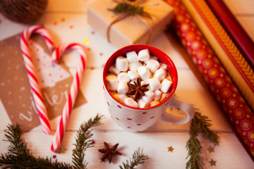 Obraz na płótnie Canvas Cup of hot Chocolate drink. Cocoa with Marshmallows and cinnamon on wooden background with Christmas decorations.