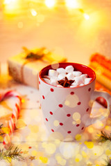 Cup of hot Chocolate drink. Cocoa with Marshmallows and cinnamon on wooden background with Christmas decorations.