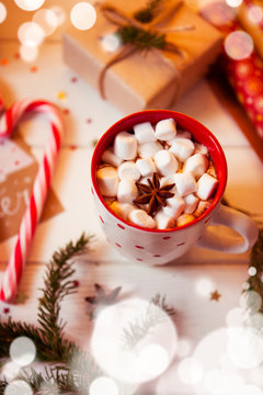 Cup of hot Chocolate drink. Cocoa with Marshmallows and cinnamon on wooden background with Christmas decorations.