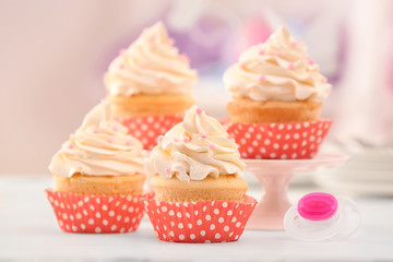 Tasty cupcakes for baby shower party on table