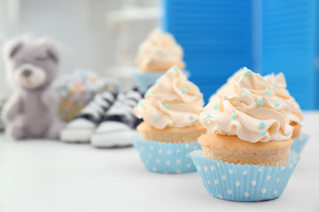 Tasty cupcake for baby shower party on table