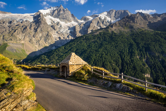 The Oratory of Le Chazelet at sunset with the peaks of La Meije and Rateau and their glaciers. Ecrins National Park, Le Chazelet, Hautes-Alpes, Southern French Alps, France