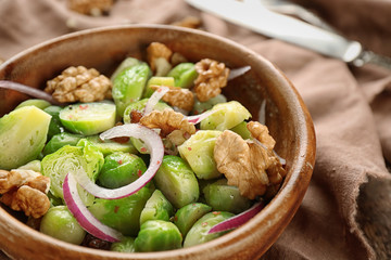 Bowl with brussel sprout salad on table