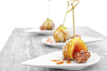 Ripe fig and walnut served with caramel sauce on plate
