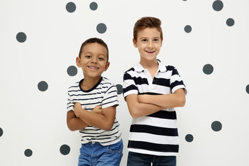 Cute stylish boys on light background