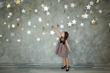 Fototapeta na wymiar portrait of a happy girl on a background of stars
