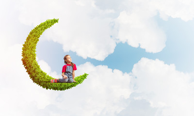 Concept of careless happy childhood with girl dreaming about something
