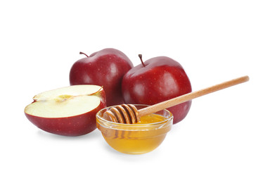 Ripe red apples and bowl with honey on white background