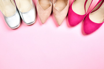 Female stylish shoes on color background