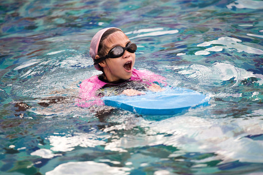 Cute little girl learning to swim