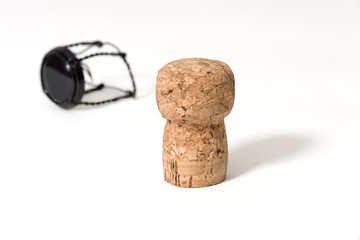 Cork from champagne wine bottle with muselet holding wire - concept isolated on white background with copy space