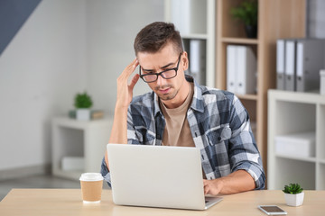 Attractive man with laptop at home