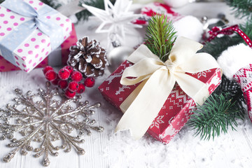 Obraz na płótnie Canvas Christmas fir tree, decor, gift box and mittens