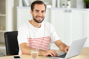 Attractive man with laptop in office