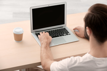 Man using laptop indoors