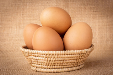 Eggs in a basket on  gunny (sackcloth)  background