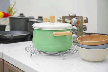 Stewpan and bowls on table in kitchen